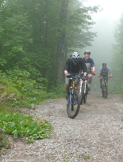Mountain Bikers emerging out of the fog