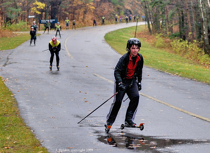 Wet and stoic roller skiiers